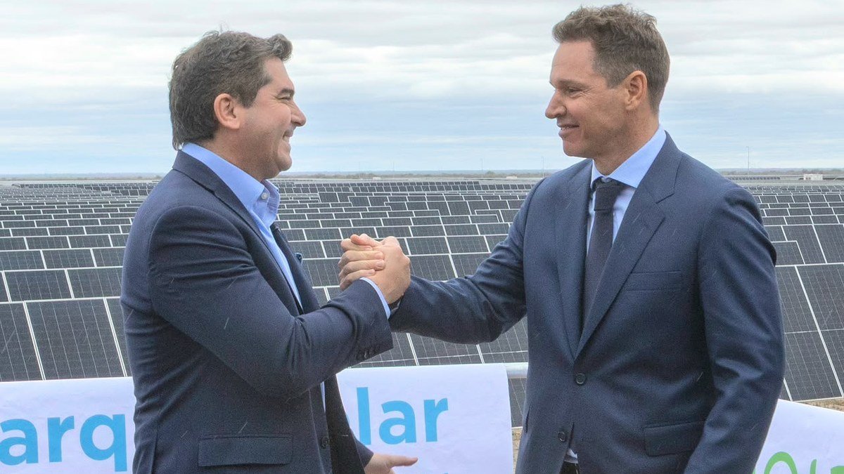El gobernador Marcelo Orrego y Jorge Brito se dan la mano frente a los paneles del parque solar