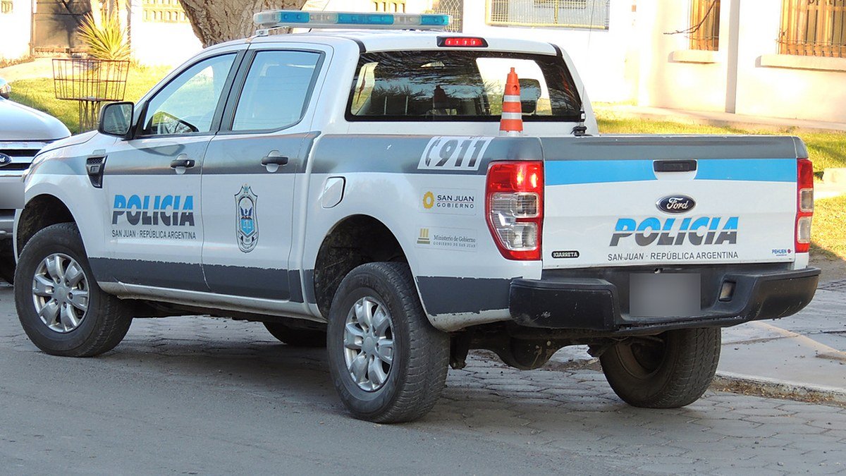Camioneta blanca de la Policía de San Juan estacionada en una calle, vista desde atrás
