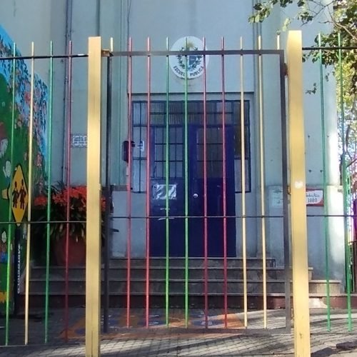 Reja de colores y mural en la entrada de un jardín de infantes