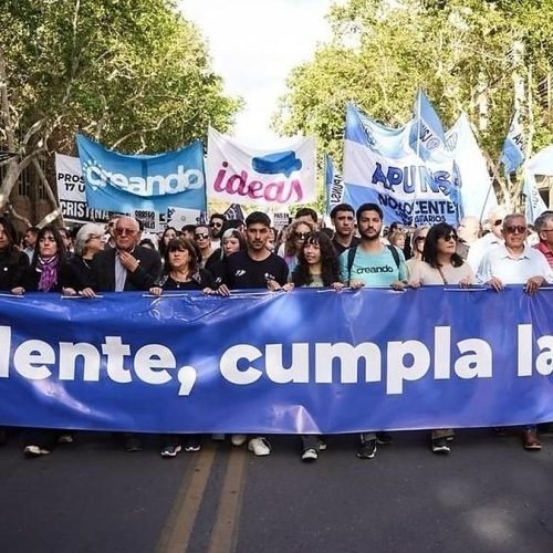 Autoridades de la UNSJ encabezan la Marcha Federal Universitaria en San Juan detrás de una bandera